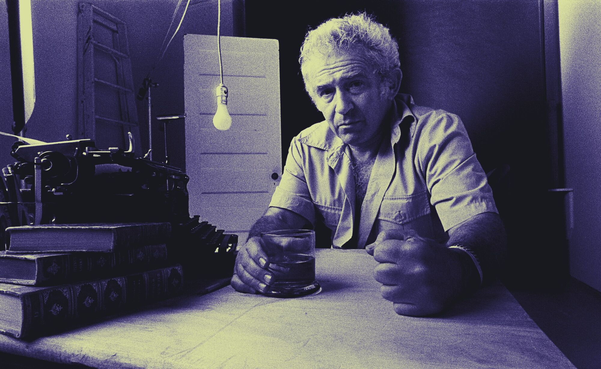 Norman Mailer at his writing table, 1977