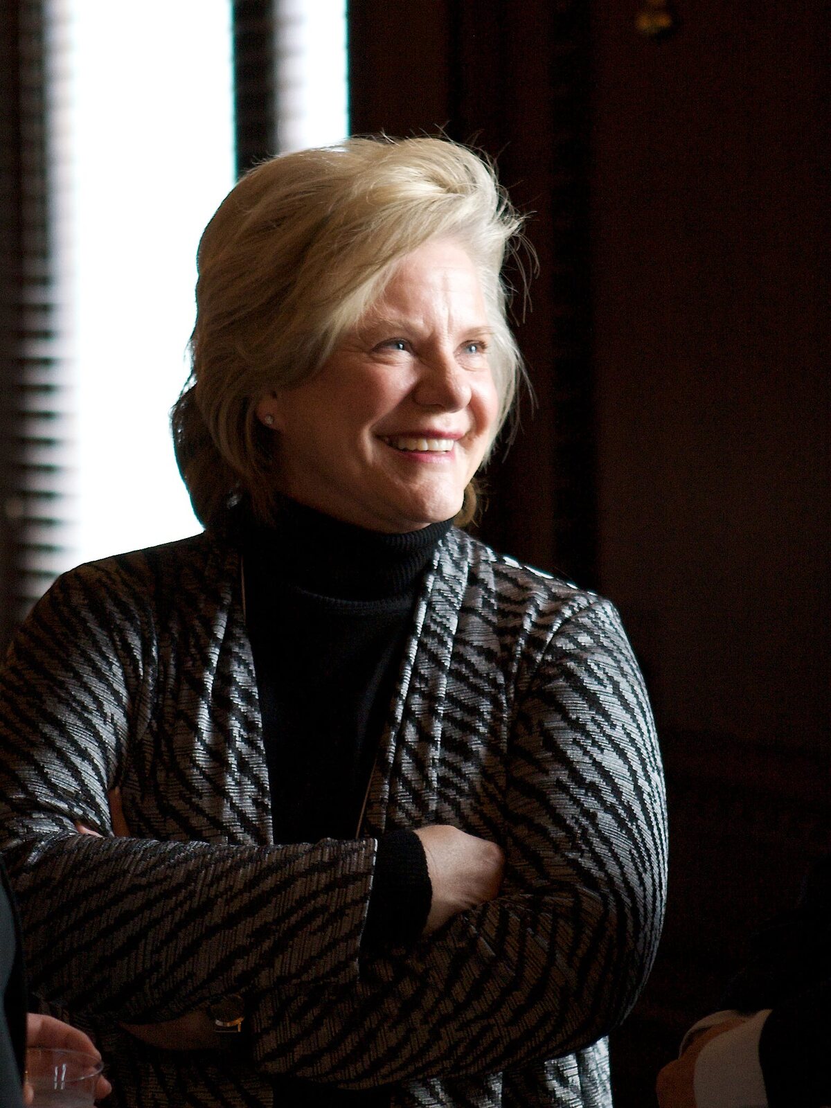 Deborah Martinson, smiling, arms folded, in 2010